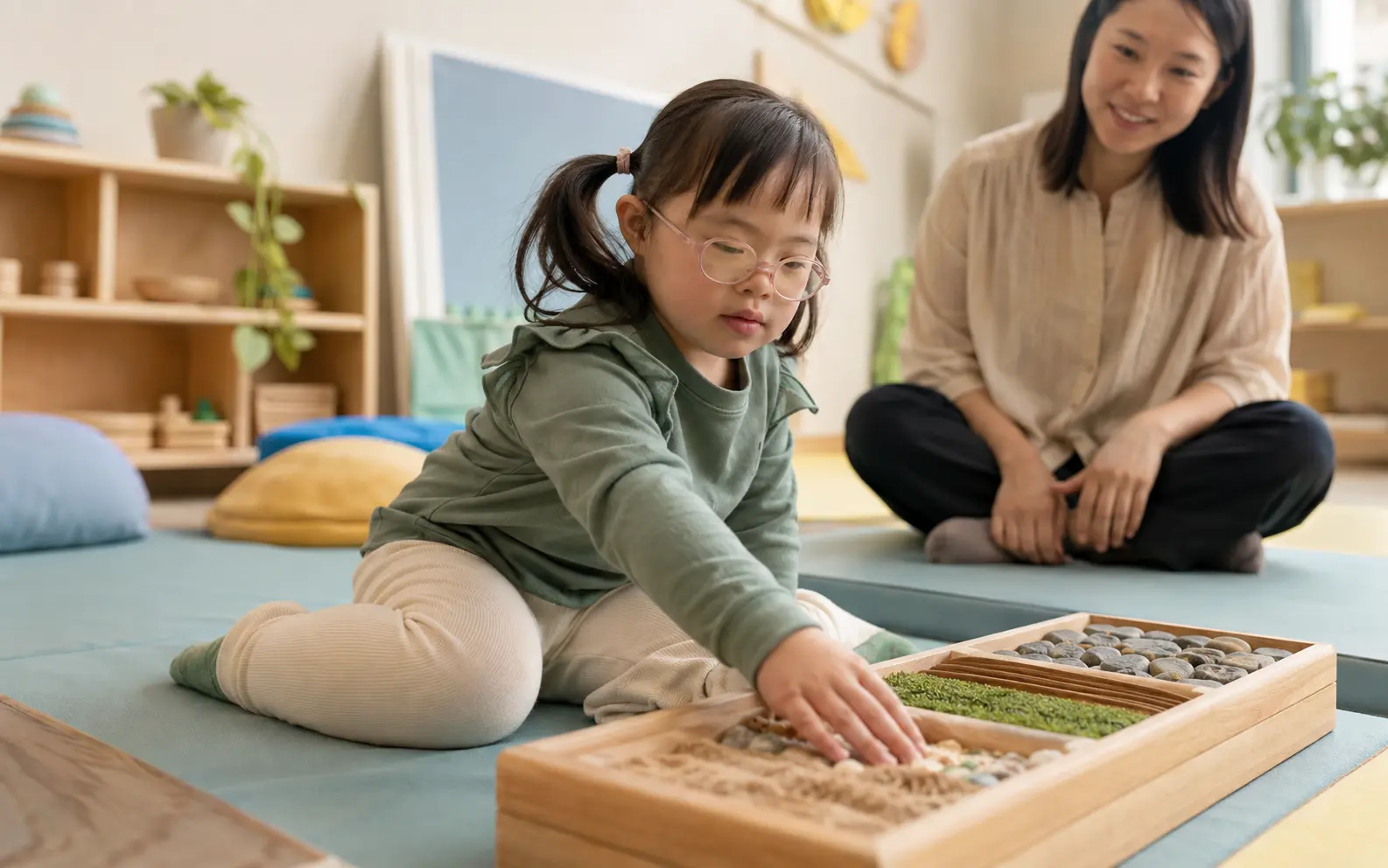 A child with Down syndrome confidently exploring a calm sensory-learning space